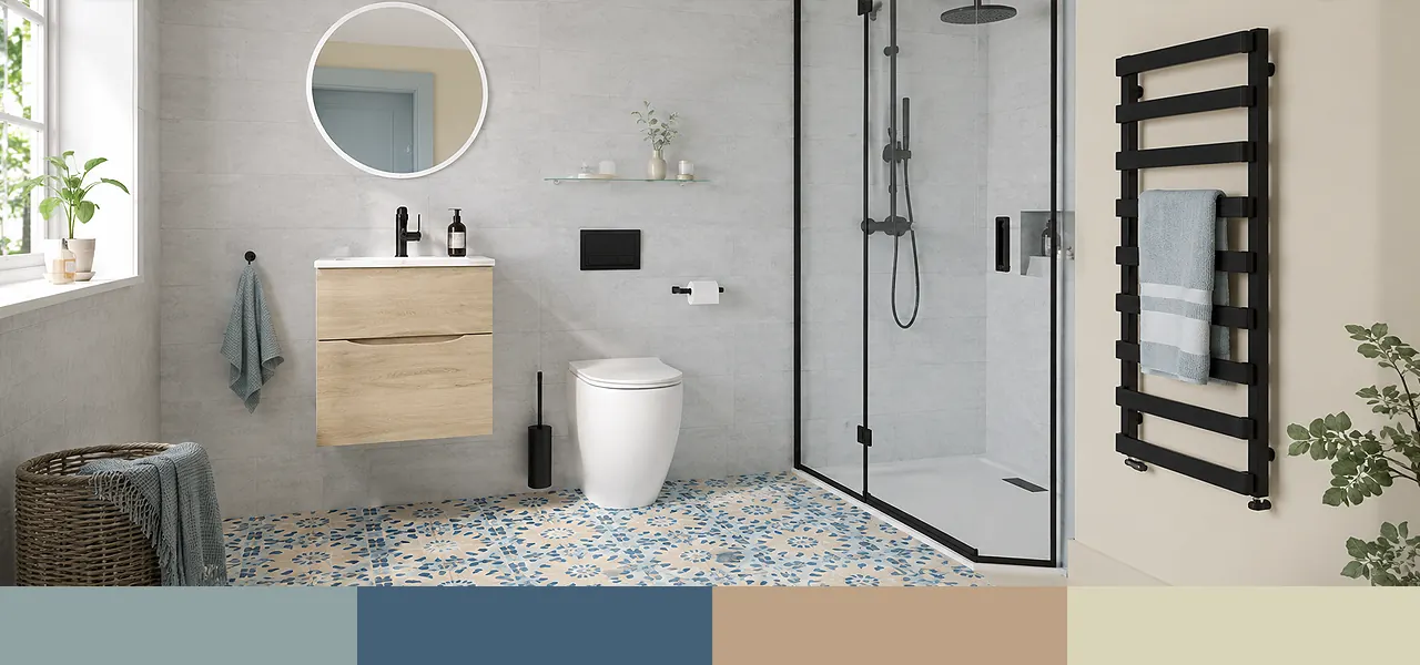 A modern bathroom featuring a light oak wall-mounted vanity unit with countertop basin, wall-hung toilet, walk-in shower with matt black fittings, matt black heated towel rail, round mirror, and patterned blue and beige floor tiles, paired with a navy, sky blue, sand, and grey colour palette swatch.