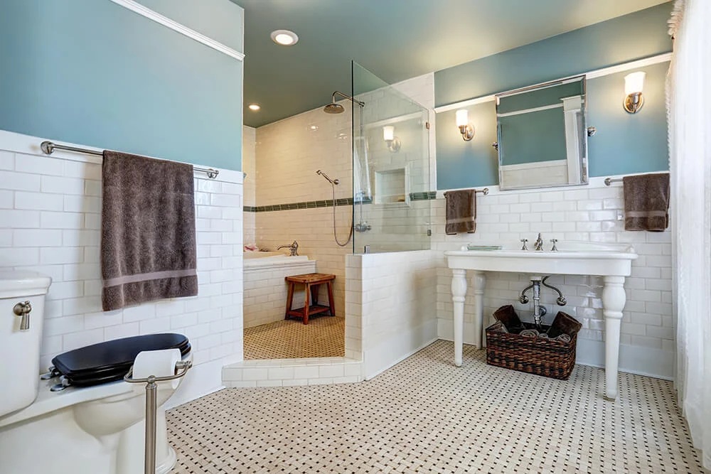 Teal and dark indigo tiling with black bathtub