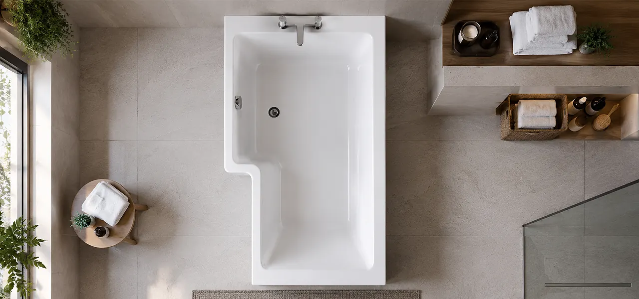 Overhead view of a white L-shaped shower bath showing the squared shower end, stepped bathing section, and side-mounted chrome taps.