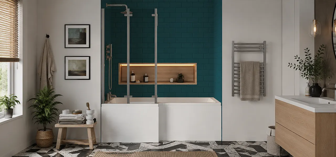 White L-shaped shower bath with a double-panel folding glass screen and overhead shower, against a teal metro-tiled wall with a recessed storage niche.