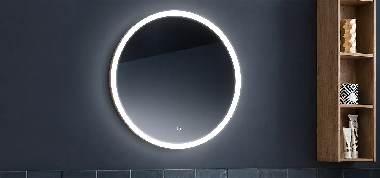 Round borderlit LED illuminated bathroom mirror with a soft glowing edge and a touch sensor, on a dark wall.