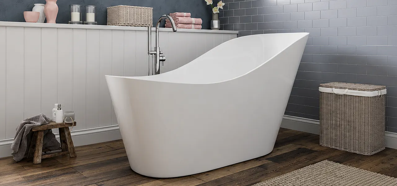 White single-ended slipper bath with a raised reclining end and floor-mounted chrome tap, in a loft bathroom with grey metro tiles and a wood floor.
