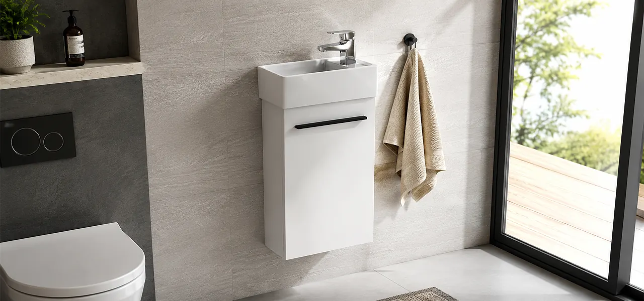 White wall-hung cloakroom vanity unit with a slimline basin, side-mounted chrome tap and a black bar handle.