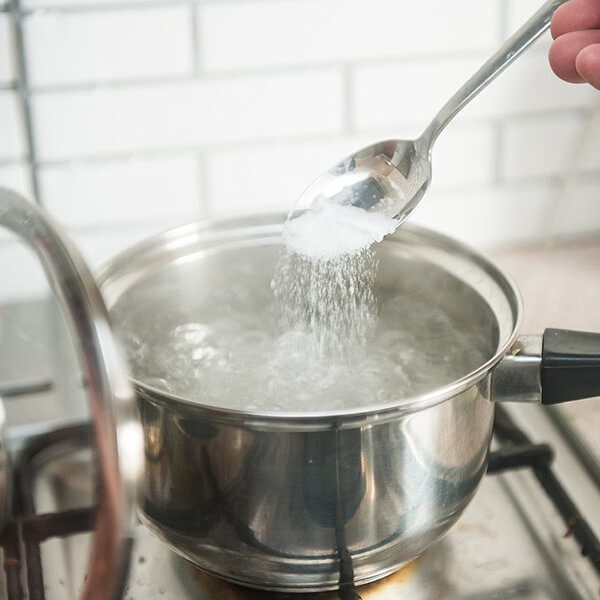 Adding salt to boiling water